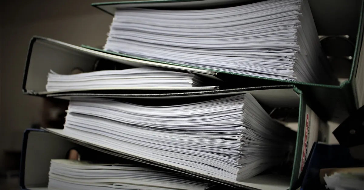 Stacked binders full of paper, like a drawing set whose order depends on its sheet numbers